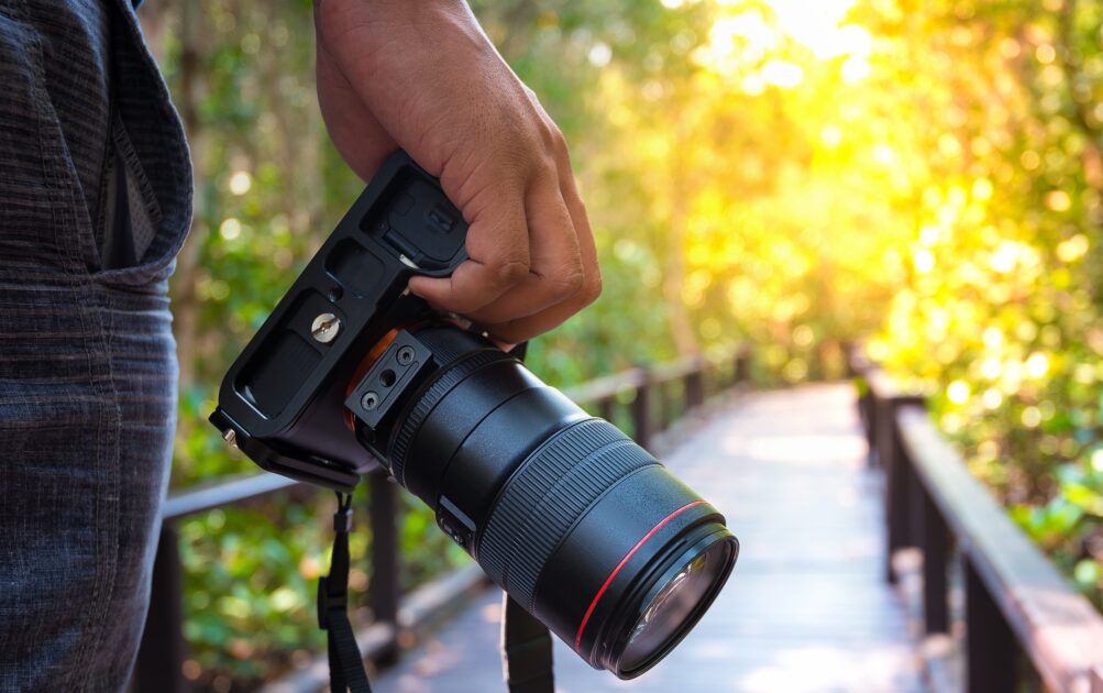 Une main tient un appareil photo.